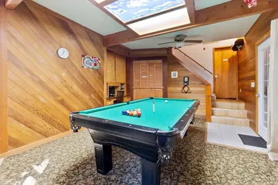 a pool table in a room with a ceiling at HotTub PingPong Arcade Billiard Pets AC Piano BBQ Art - by SharpCat in Twain Harte