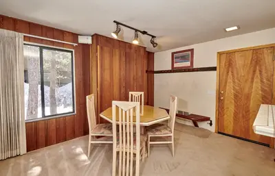 a dining room with a wooden table and chairs at St Anton Condos #83 condo in Mammoth Lakes