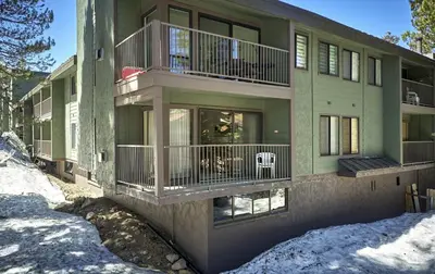 a apartment building with balconies and snow on the ground at St Anton Condos #83 condo in Mammoth Lakes