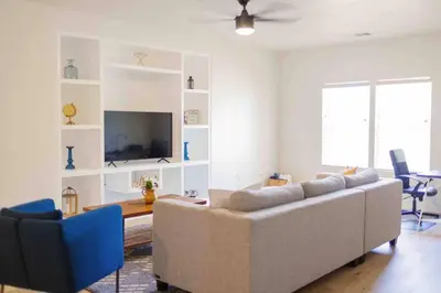 a living room with a couch and a tv at Gateway Retreat: Short Drive to the Sequoias in Exeter