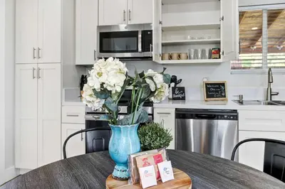 a vase of flowers on a table in a kitchen at Country Charmer Single Story Cottage Pet Friendly in Loomis