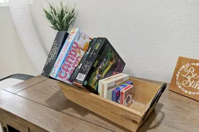 a table with a shelf of books on it at Country Charmer Single Story Cottage Pet Friendly in Loomis