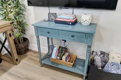 a blue table with books on it in a room at Country Charmer Single Story Cottage Pet Friendly in Loomis