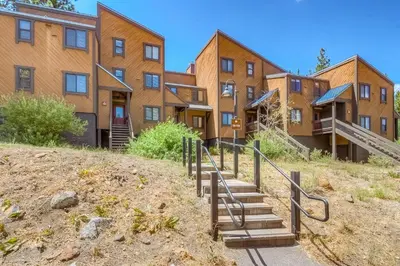 a building on a hill with stairs in front at Silver Strike Sanctuary in Truckee