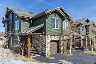 a green house with a garage at Snowcreek V 984 in Mammoth Lakes