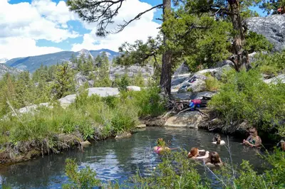 a group of people swimming in a river at Alpine Cottage in Shaver Lake