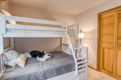 a bedroom with bunk beds with a dog laying on the bed at Basque in Nature in Truckee