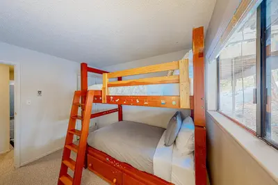 two bunk beds in a room with a window at Falcon Nest in Incline Village
