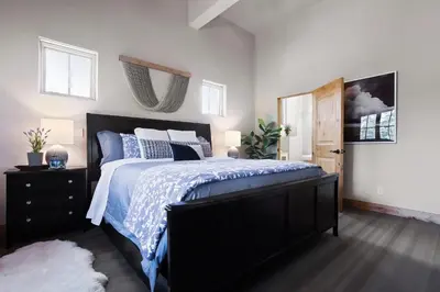 a bedroom with a bed with a blue and white comforter at Modern Condo - EV Plug In - SM 301 in Bear Valley