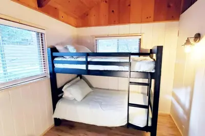 two bunk beds in a small room with a window at Redwood Retreat, Mountains, Adventure and Nature in Ponderosa