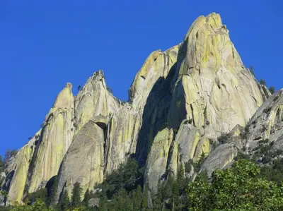 a large rocky mountain with trees in front of a blue sky at Redwood Retreat, Mountains, Adventure and Nature in Ponderosa