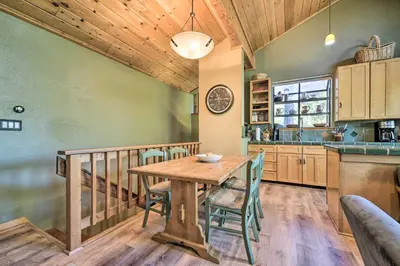 a kitchen and dining room with a wooden table and chairs at Hot Tub and Ski Shuttle Northstar Resort House in Truckee