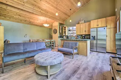 a living room with a couch and a kitchen at Hot Tub and Ski Shuttle Northstar Resort House in Truckee