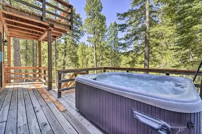 a hot tub on a deck in the woods at Hot Tub and Ski Shuttle Northstar Resort House in Truckee