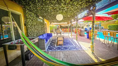 a hammock on a patio next to a pool at Tropical Paradise in Fresno
