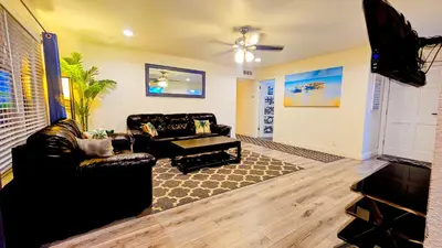 a living room with a couch and a table at Tropical Paradise in Fresno