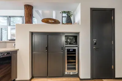 a kitchen with gray cabinets and a refrigerator at Great Views Fully Renovated Luxury 4 Bedroom 3 Full Bathrooms and Half Bath Snowcreek 732 Phase V in Mammoth Lakes