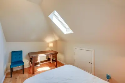 a bedroom with a bed and a desk and a skylight at Colfax Getaway with Hot Tub, Mountain Views! in Colfax