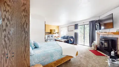 a bedroom with a bed and a living room at La Vista Blanc #59 condo in Mammoth Lakes