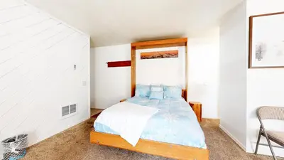 a bedroom with a bed with a wooden headboard at La Vista Blanc #59 condo in Mammoth Lakes