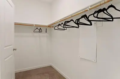 a room with a white wall with black hangers at Stunning River Islands Home Near Lake & Boat House in Lathrop