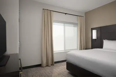 a bedroom with a bed and a large window at Residence Inn by Marriott Fresno Clovis in Clovis