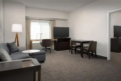 a living room with a couch and a table and a television at Residence Inn by Marriott Fresno Clovis in Clovis