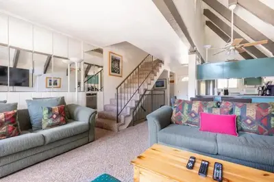 a living room with two couches and a staircase at Perfect Ski Rental 2 blocks from Village Gondola in Mammoth Lakes