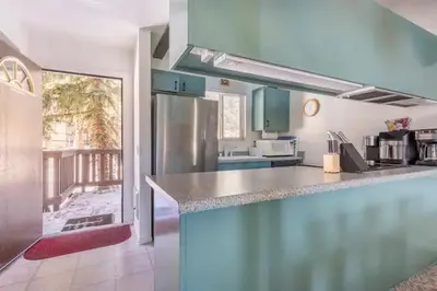 a kitchen with a counter top and a refrigerator at Perfect Ski Rental 2 blocks from Village Gondola in Mammoth Lakes