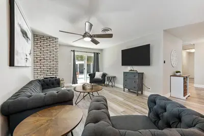 a living room with two couches and a flat screen tv at Fully Renovated 4 Bedroom Home with Pool! in Roseville