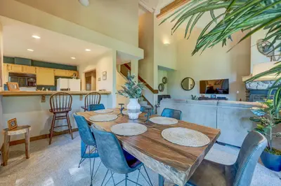 a dining room with a wooden table and blue chairs at Incline Escape in Incline Village