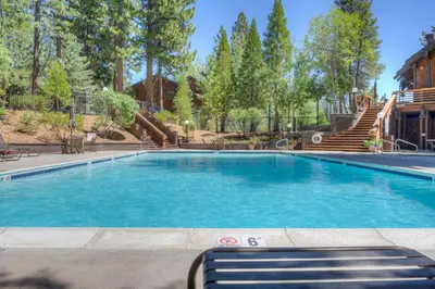 a swimming pool in a resort with trees at Incline Escape in Incline Village