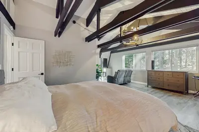 a bedroom with a large bed and a desk at Sierra Nevada Serenity in South Lake Tahoe