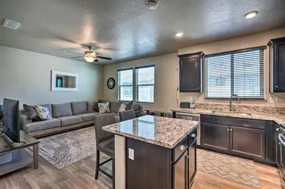 a kitchen and living room with a couch and a table at Pet-Friendly Elk Grove Retreat with Balcony! in Elk Grove