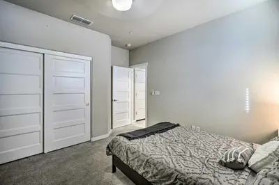 a bedroom with a bed and two closet doors at Pet-Friendly Elk Grove Retreat with Balcony! in Elk Grove