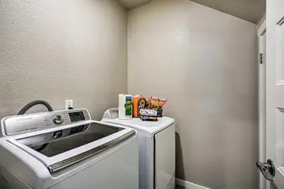a small laundry room with a washer and dryer at Pet-Friendly Elk Grove Retreat with Balcony! in Elk Grove