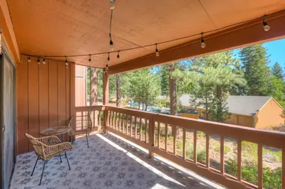 a balcony with a chair and a view of a yard at Incline Village Stunner in Incline Village