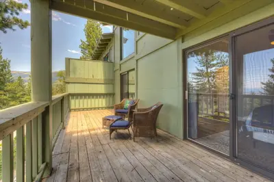 a screened porch with two chairs and sliding glass doors at Casa Azul in Incline Village