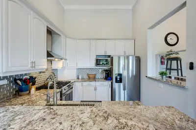a kitchen with white cabinets and a stainless steel refrigerator at Casa Azul in Incline Village