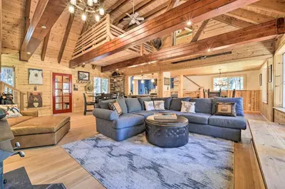 a living room with a couch and a table at Waterfront Echo Lake Cabin with Deck, Mtn Views in Twin Bridges
