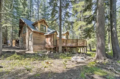 a log cabin in the woods in the woods at Waterfront Echo Lake Cabin with Deck, Mtn Views in Twin Bridges