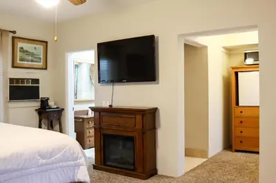 a bedroom with a flat screen tv on a wall at The Bonnie Inn Unit 5 with Breakfast Nook in San Andreas