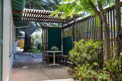 a patio with a wooden pergola and a bench at The Bonnie Inn Unit 6 in San Andreas