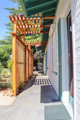 a wooden pergola on the side of a building at The Bonnie Inn Unit 6 in San Andreas
