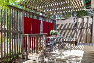a wooden fence with a table and chairs on a patio at The Bonnie Inn Unit 6 in San Andreas