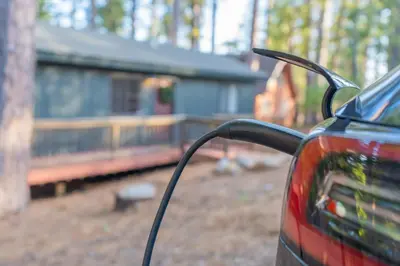 a car parked in front of a house with a train at Sweet Arnold Cabin in Arnold