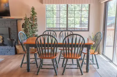 a dining room table and chairs with a christmas tree at Sweet Arnold Cabin in Arnold