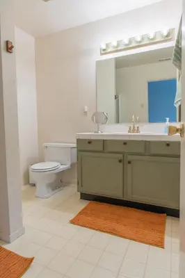 a bathroom with a sink and a toilet and a mirror at Sweet Arnold Cabin in Arnold