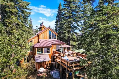 a large wooden house in the woods with trees at Amazing Architecture - Views all around VH#113 in Tamarack