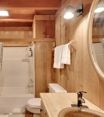 a bathroom with a sink and a toilet and a mirror at Amazing Architecture - Views all around VH#113 in Tamarack